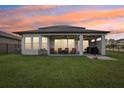 Covered patio with seating area and grill at 30425 Pecan Valley Loop, Wesley Chapel, FL 33543