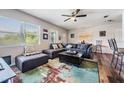 Bright and airy living room features plush seating, large windows, wood floors and a modern rug at 1611 Stevenson Dr, Clearwater, FL 33755