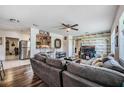 Open-concept living room featuring wood floors, modern decor, ceiling fan, and access to kitchen at 1611 Stevenson Dr, Clearwater, FL 33755