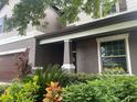 Two-story house exterior, landscaping and front door at 3015 Winglewood Cir, Lutz, FL 33558
