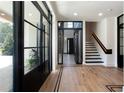 Light-filled entryway with black-framed doors and hardwood floors at 3305 W Beaumont St, Tampa, FL 33611
