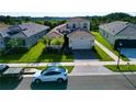 Two-story house with light brown exterior and two-car garage at 32676 Tree Of Life Ave, Wesley Chapel, FL 33543