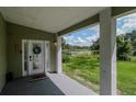 Inviting front entrance with a view of a tranquil lake at 20605 Preston Ln, Lutz, FL 33558