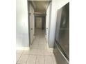 Clean hallway with light walls and tile flooring at 7634 Cortez Ct, Tampa, FL 33615