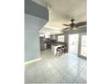 Kitchen features island with seating and access to patio at 7634 Cortez Ct, Tampa, FL 33615