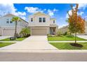 Two-story home with a neutral color palette and a two-car garage at 5472 Summer Sunset Dr, Apollo Beach, FL 33572