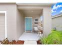Inviting front porch with a light teal door and cozy seating at 5472 Summer Sunset Dr, Apollo Beach, FL 33572