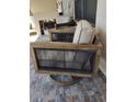 Two swivel patio chairs with light beige cushions and dark brown wooden frames at 9920 Eagles Point Cir # 2, Port Richey, FL 34668