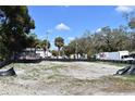 A vacant lot is ready for development with a mix of sandy soil and sprouting grass at 210 E Janette Ave, Tampa, FL 33603
