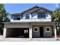 Under-construction two-story home featuring a large garage and visible framework, set against a clear blue sky at 3204 N Morgan St, Tampa, FL 33603