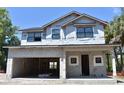Under-construction two-story home featuring a large garage and visible framework, set against a clear blue sky at 3204 N Morgan St, Tampa, FL 33603