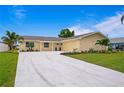 Newly renovated single-story home with a two-car garage and landscaped yard at 8716 Elmwood Ln, Tampa, FL 33615