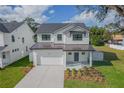 Two-story farmhouse style home with white siding and a dark metal roof at 3204 N Morgan St, Tampa, FL 33603
