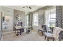 Bright home office with built-in desk, comfortable seating, and large windows at 18227 Fattoria Ter, Lakewood Ranch, FL 34211