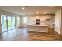 Bright, open-concept kitchen with white cabinets, island, and stainless steel appliances at 18142 Beach Ranch Ter, Lakewood Ranch, FL 34211