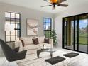 Bright living room with beige sofa, and sliding doors leading to the patio at 227 Mystic Falls Dr, Apollo Beach, FL 33572