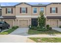 Three townhouses with garages and landscaping at 8491 Essington St, New Port Richey, FL 34654