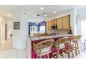 Kitchen with granite countertops, wood cabinets, and breakfast bar at 281 Hidden Bay Dr # 101, Osprey, FL 34229