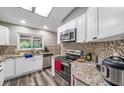 Modern kitchen with granite countertops and stainless steel appliances at 7127 Otter Creek Dr, New Port Richey, FL 34655