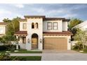 Two-story house with stucco exterior, tile roof, and two-car garage at 320 W Park Ave, Tampa, FL 33602