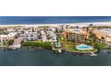 Condo community near beach with multiple buildings and pools, aerial view at 10301 Gulf Blvd # 201, Treasure Island, FL 33706