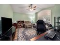 Home office with TV, desk, and comfortable seating at 4124 Beaumont Loop, Spring Hill, FL 34609