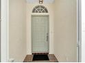 Front entry with a light green door and terracotta tile floor at 2206 Mayfield Palms Ln # 69, Sun City Center, FL 33573