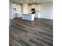 Open-concept floorplan with wood-look flooring, a kitchen island and pendant lights above and recessed lighting throughout at 16013 7Th E Ave, Bradenton, FL 34212