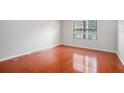 Empty bedroom with hardwood floors and window at 2220 Chianti Pl # 8-0812, Palm Harbor, FL 34683