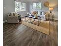 Bright living room with modern decor, hardwood floors, and ample natural light through large windows at 3763 Dartmouth N Ave, St Petersburg, FL 33713