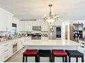 Bright kitchen featuring white cabinets, granite counters, and an island with seating at 4300 41St N St, St Petersburg, FL 33714