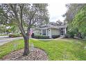 House exterior with American flag and manicured lawn at 2447 Nantucket Harbor Loop # 112, Sun City Center, FL 33573