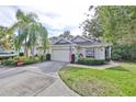 Front view of charming house with American flags at 2447 Nantucket Harbor Loop # 112, Sun City Center, FL 33573