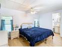 Main bedroom with a king-size bed, nightstands, and ample closet space at 35801 Verda Dr, Zephyrhills, FL 33541