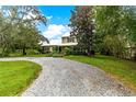 Gravel driveway leading to charming house at 29249 Wilpayne Rd, Brooksville, FL 34602