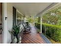 Inviting front porch with rocking chairs and landscaping at 29249 Wilpayne Rd, Brooksville, FL 34602