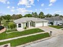 Beautiful aerial view of a single-story home featuring a well-manicured lawn, landscape and three-car garage at 13102 Prestwick Dr, Riverview, FL 33579