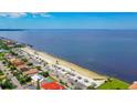 A scenic view of the coastal community by the beach with palm trees, cabanas, and street parking at 4844 Booth Bay Dr, New Port Richey, FL 34652