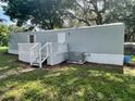 Mobile home with a gray exterior and a white deck at 9048 Ogalala St, New Port Richey, FL 34654