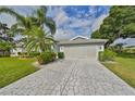 Exterior view of the home featuring a stone paved driveway at 902 Mcdaniel St # 1, Sun City Center, FL 33573