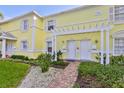 Yellow building exterior with walkway, landscaping, and pergola at 4790 Snook Se Dr, St Petersburg, FL 33705