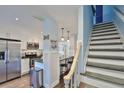 Modern kitchen with stainless steel appliances and staircase at 4790 Snook Se Dr, St Petersburg, FL 33705