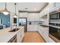 Modern kitchen with white cabinets, quartz countertops, and stainless steel appliances at 3614 Maple Bay Ln, Land O Lakes, FL 34638