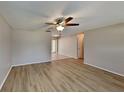 Bright living room featuring light laminate flooring and a ceiling fan at 1154 Barbour Ave, Port Charlotte, FL 33948
