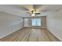 Spacious living room with light walls, laminate floors, and ceiling fan at 1154 Barbour Ave, Port Charlotte, FL 33948