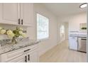 Bright kitchen with white cabinets and granite countertops at 2502 53Rd S St, Gulfport, FL 33707