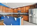 Modern kitchen featuring wood cabinets and granite island at 6843 Runner Oak Dr, Wesley Chapel, FL 33545
