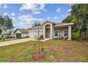 Newly built home with a white garage door and small yard at 6439 Taylor Ct, New Port Richey, FL 34653