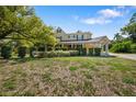 Charming two-story home featuring a covered front porch and neatly landscaped yard at 1109 Belcher Rd, Palm Harbor, FL 34683