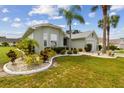 Single-story home with landscaped yard and two-car garage at 1119 Villeroy Dr, Sun City Center, FL 33573